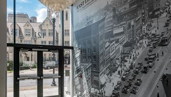 a large mural on the wall of a building with a view of a city street